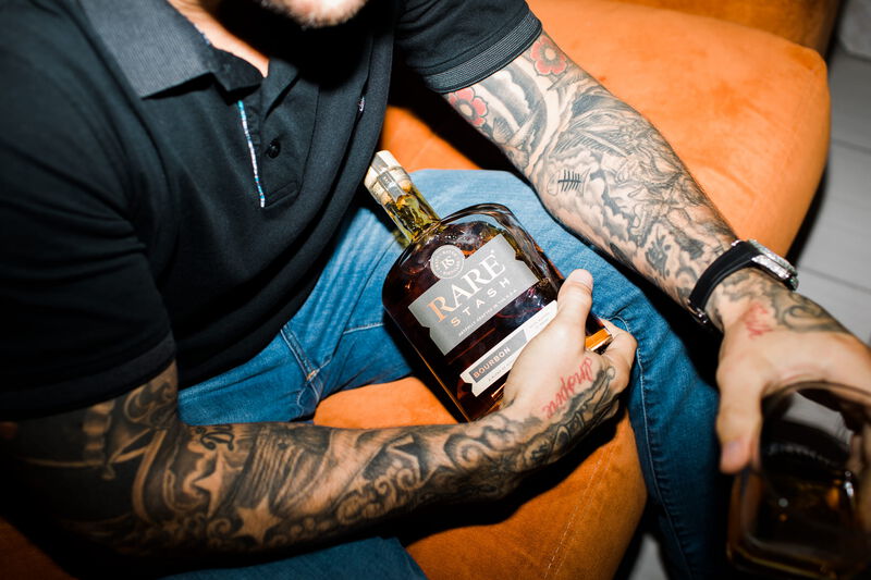 Dustin Poirier holds a bottle of Rare Stash Bourbon